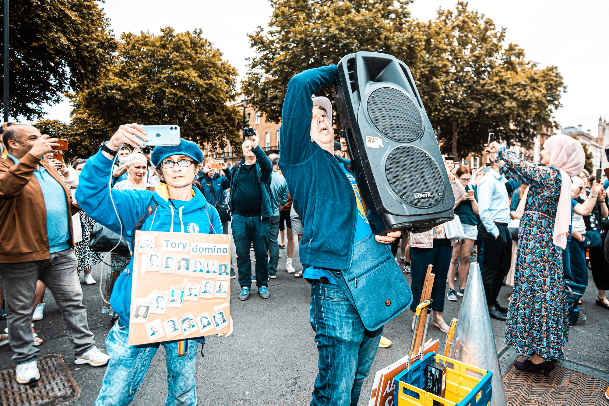 Downing Street, London:Two anti-Tory protesters with signs and a sound system