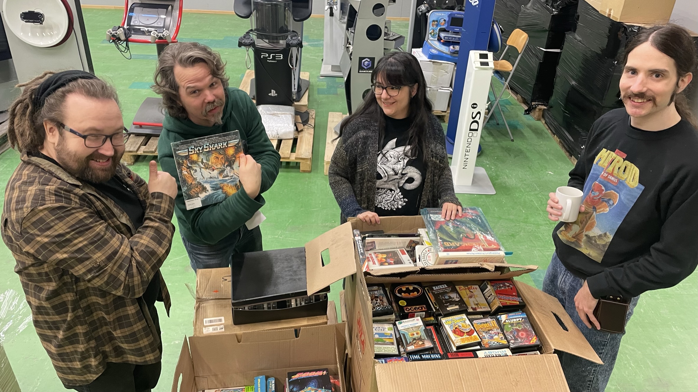 People sifting through more boxes for the Embracer Gaming Archive.