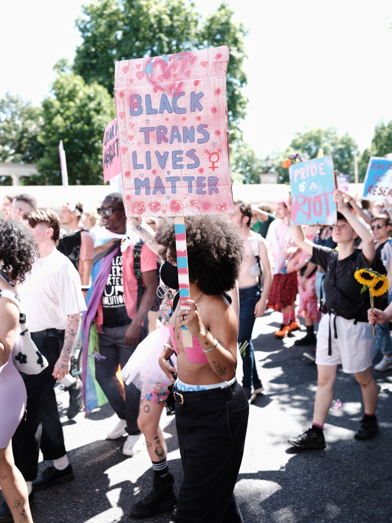 Protesters holding signs at London Trans+ Pride 2022