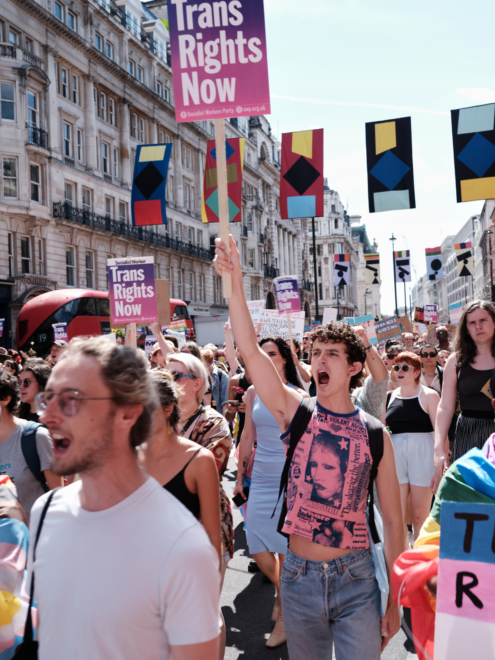 Protesters holding signs at London Trans+ Pride 2022