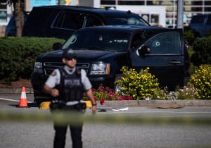 Bullet holes are seen in the windshield and passenger window of an RCMP vehicle at the scene of a shooting, in Langley, B.C., on Monday, July 25, 2022.