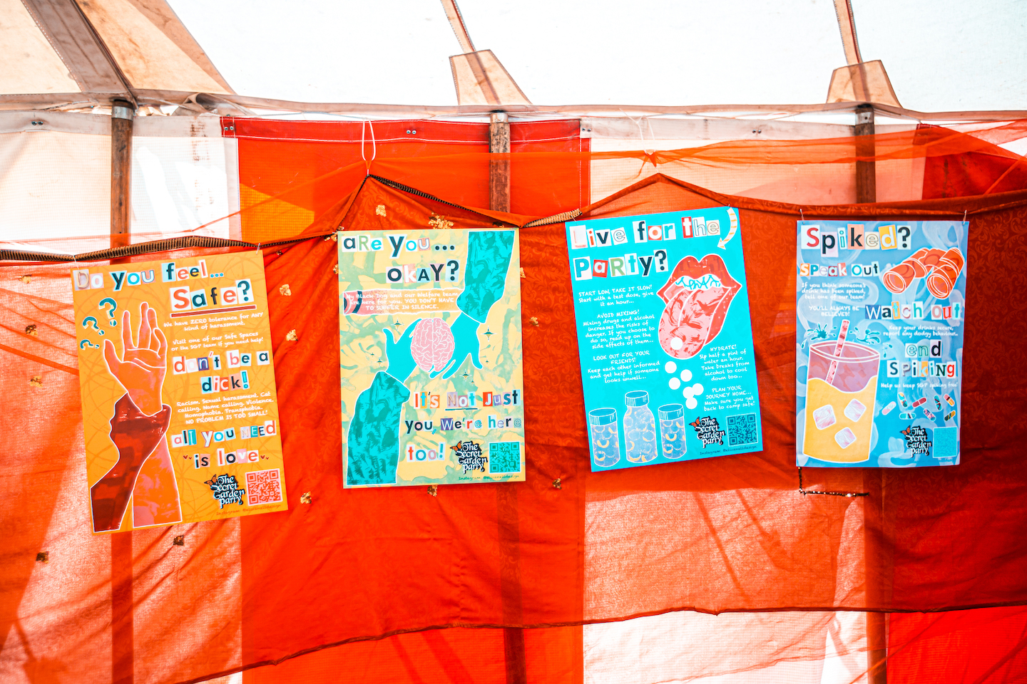 Four welfare posters on the wall of a tent.
