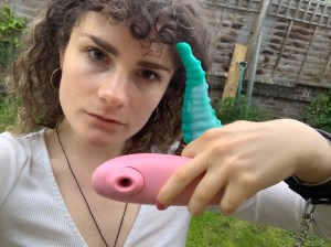 woman holding two eco-friendly sex toys