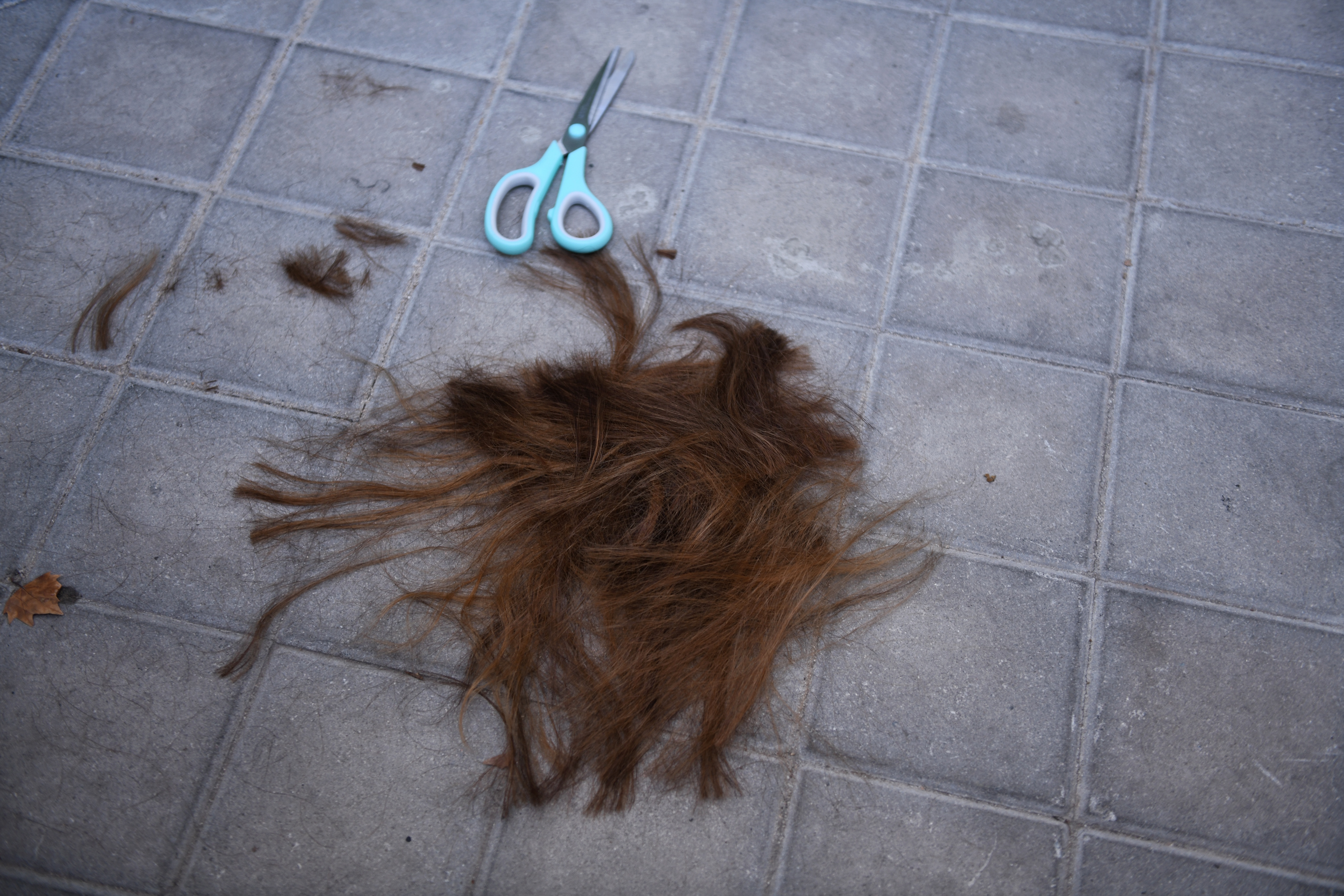 Cut hair lies on the floor outside the Iranian embassy in Madrid following a solidarity demonstration. Photo: Fernando Sanchez/Europa Press via Getty Images