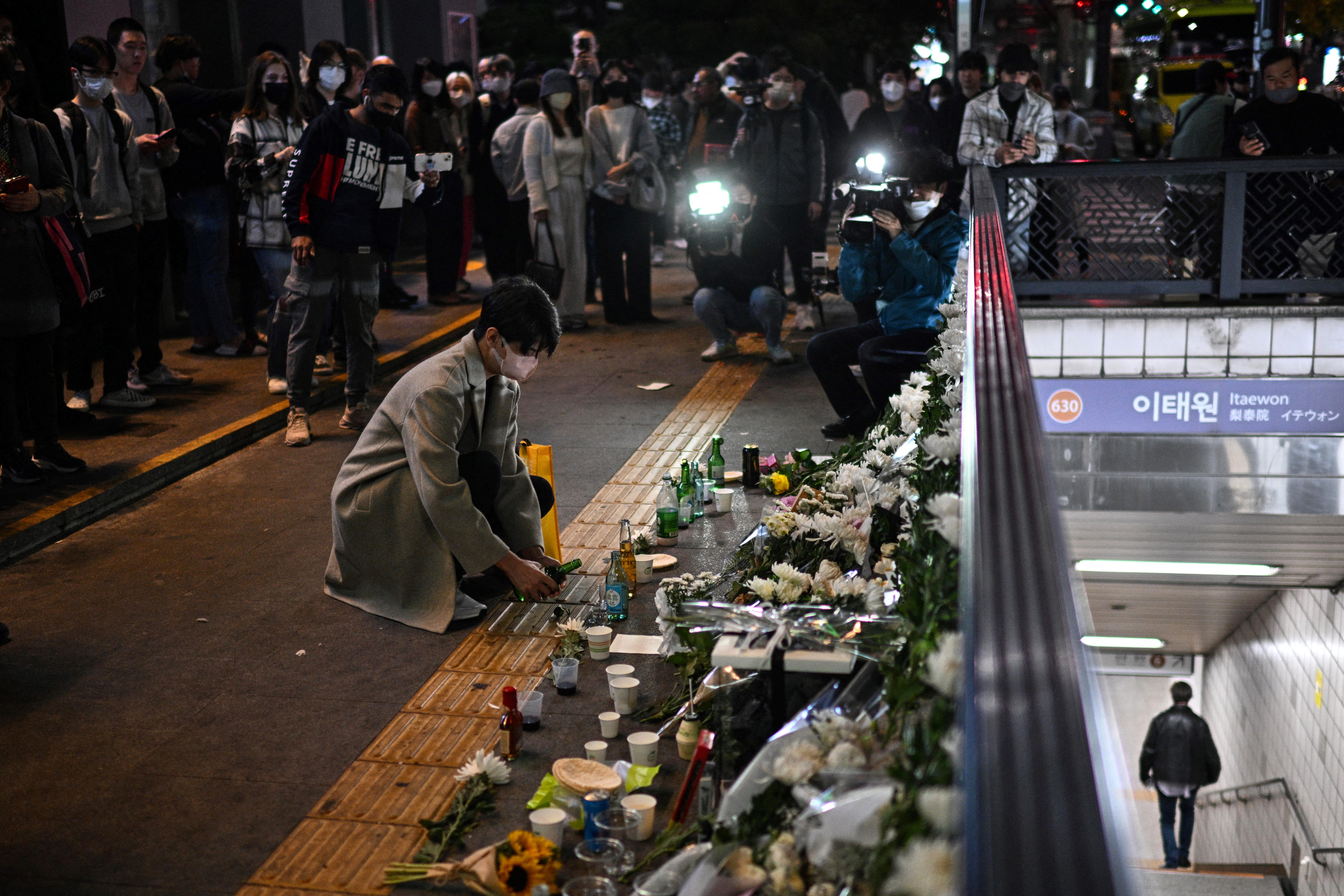 A man pays tribute to those who were killed in the crowd surge on October 29. Photo: ANTHONY WALLACE/AFP
