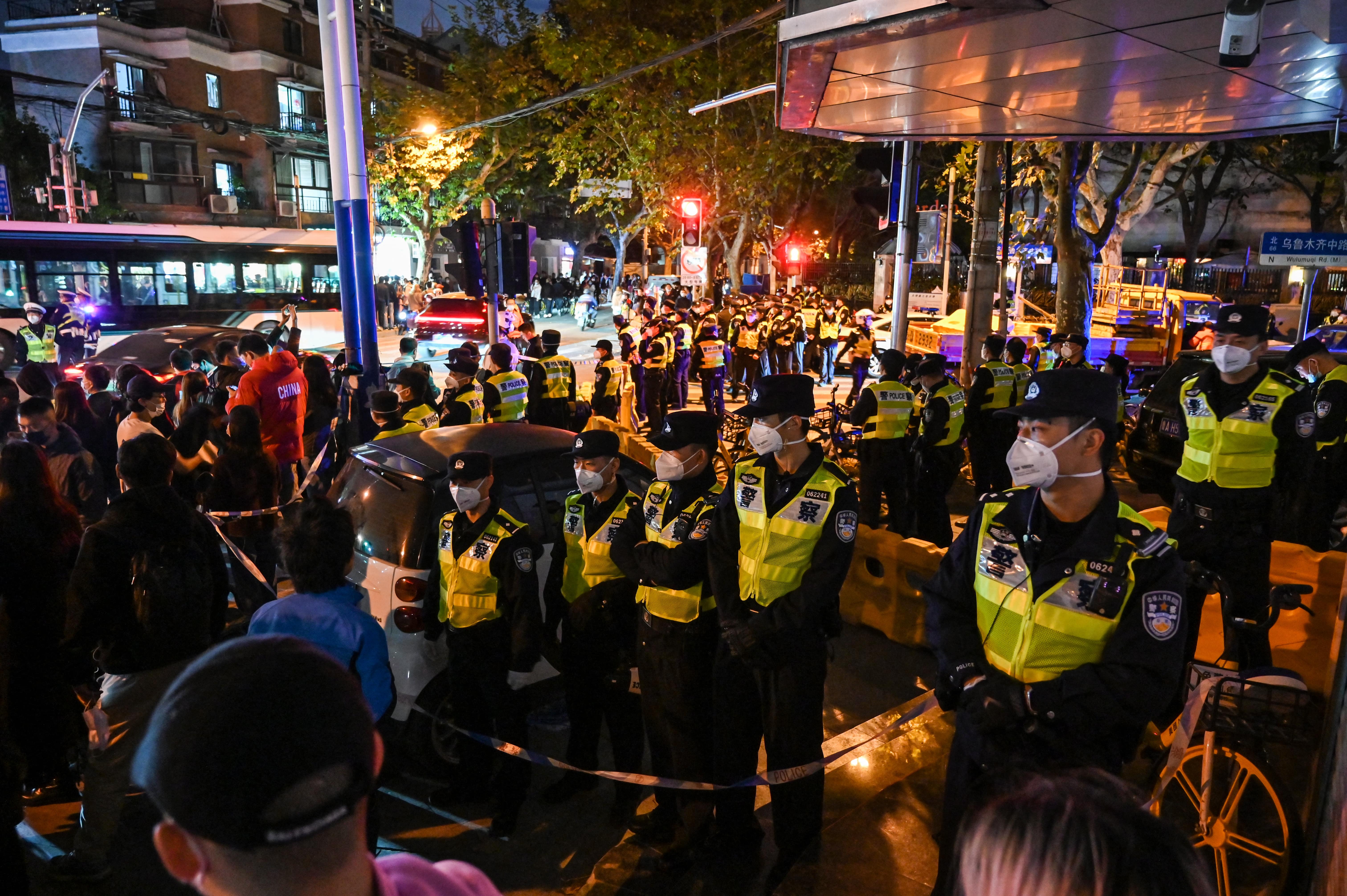 POLICE OFFICERS BLOCKED A STREET IN SHANGHAI, WHERE PROTESTS TOOK PLACE THE NIGHT BEFORE. PHOTO: HECTOR RETAMAL/AFP