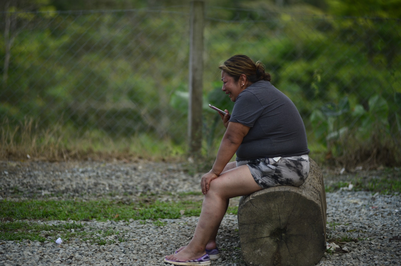 A woman cries after trekking through the Darién Gap because she was separated from family members while crossing the jungle and can’t locate them.