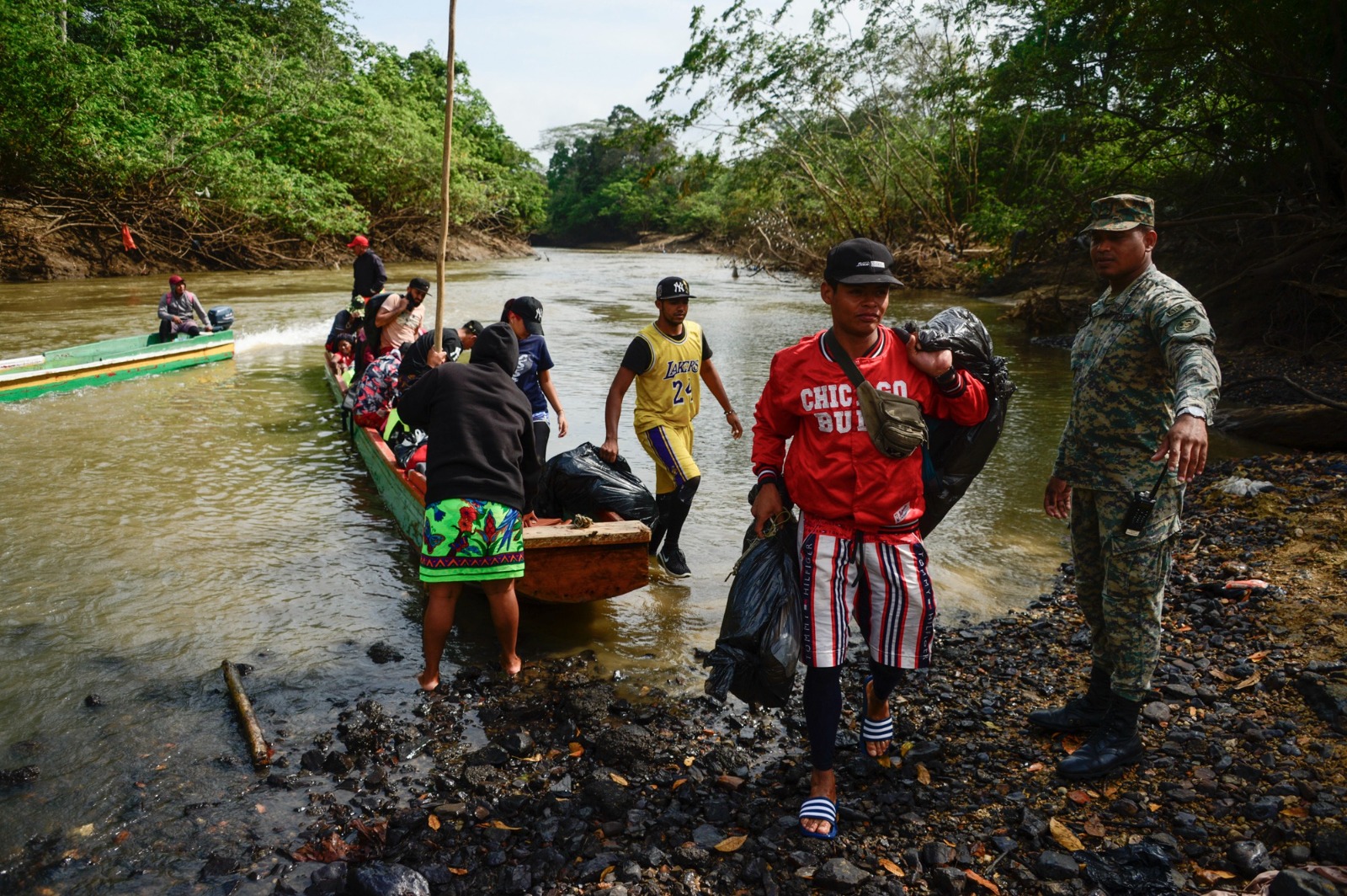 Migrants arriving on a motorized canoe at Lajas Blancas after crossing the Darién Gap.