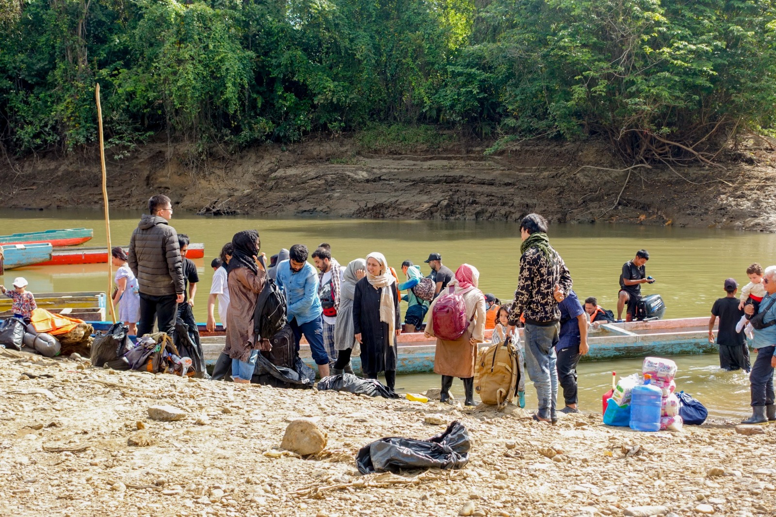 Migrants arriving on motorized canoe at Puerto Limon after crossing the Darién Gap.