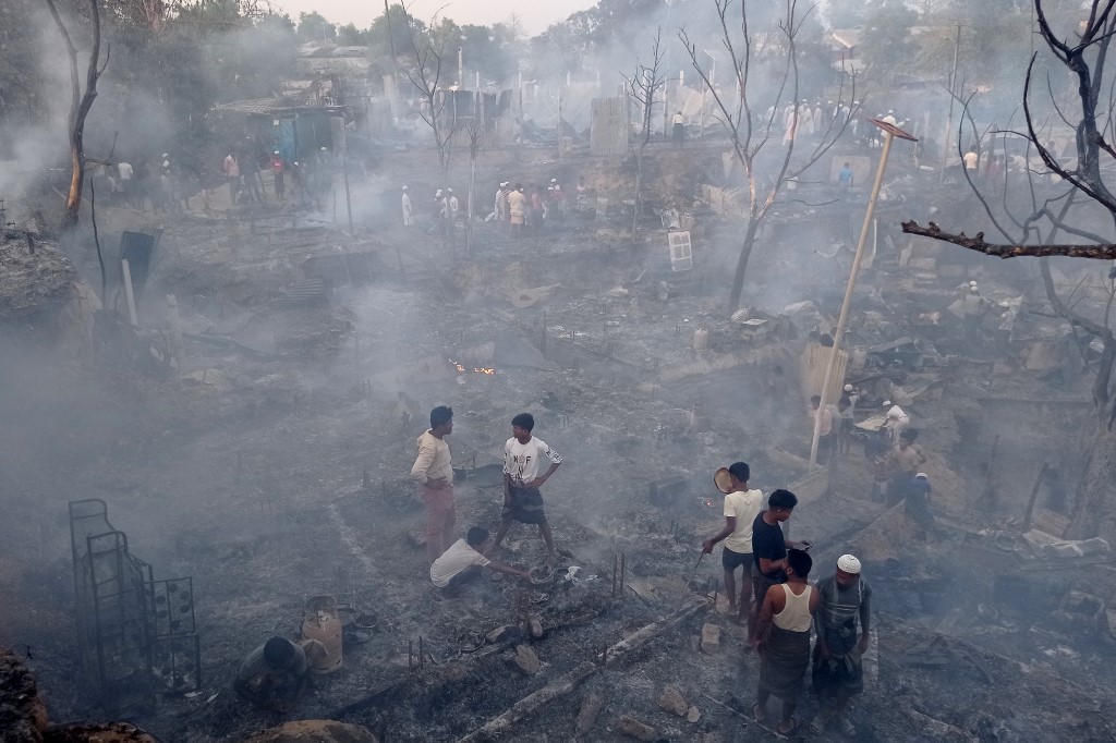 Rohingya refugees search for their belongings after the fire destroyed the shelters they lived in. The shelters, mostly made of bamboo and tarpaulin, are highly flammable. Photo: Tanbir Miraz / AFP