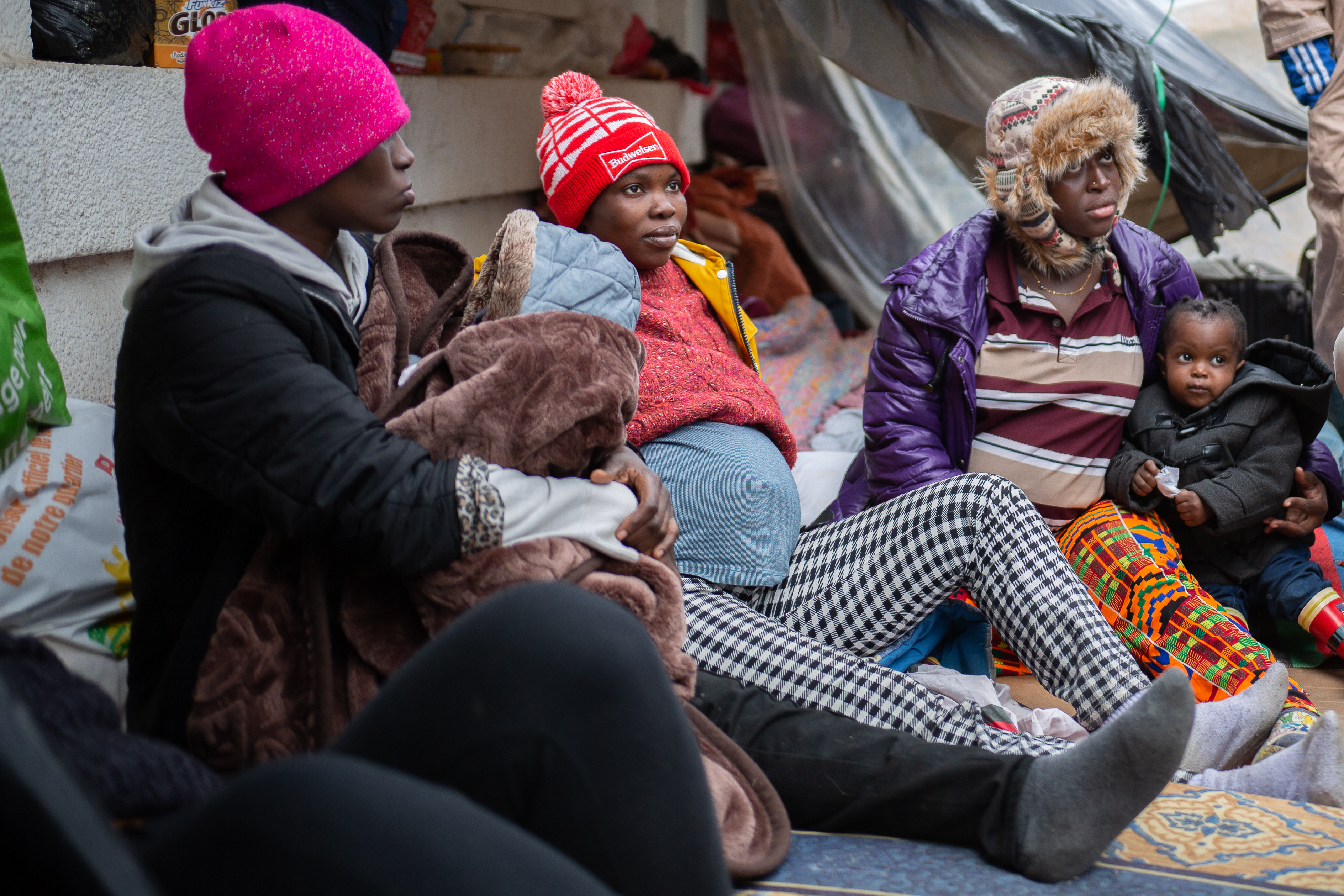 Outside the headquarters of the International Organization for Migration (IOM), migrants that have been evicted from their homes are camping out