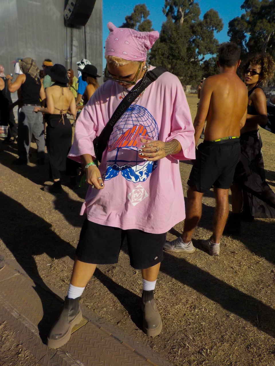 pink shirt pink bandana boots and big cool shades
