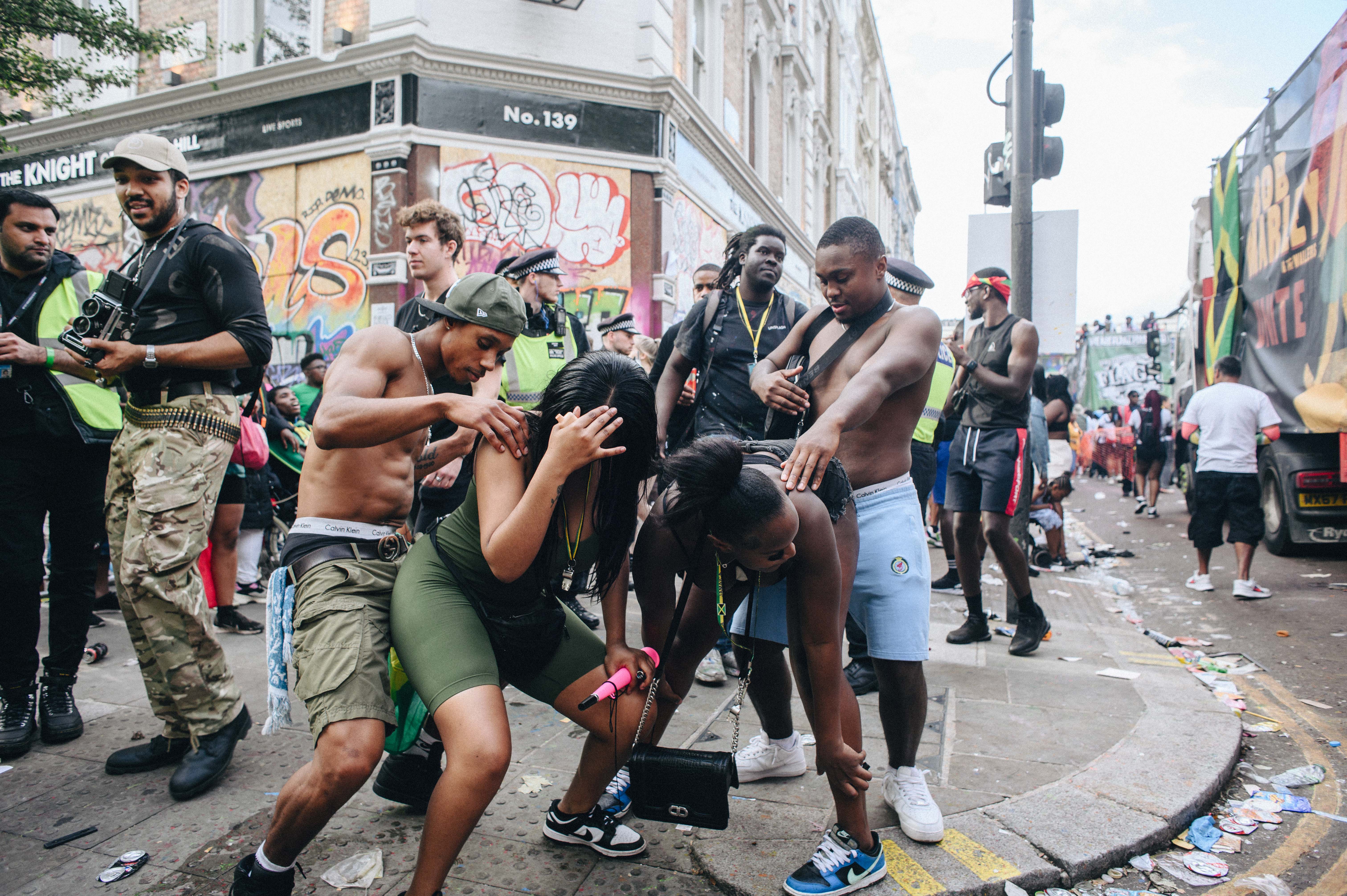 Notting Hill Carnival 2023, London: A group of teenagers whining on a street corner