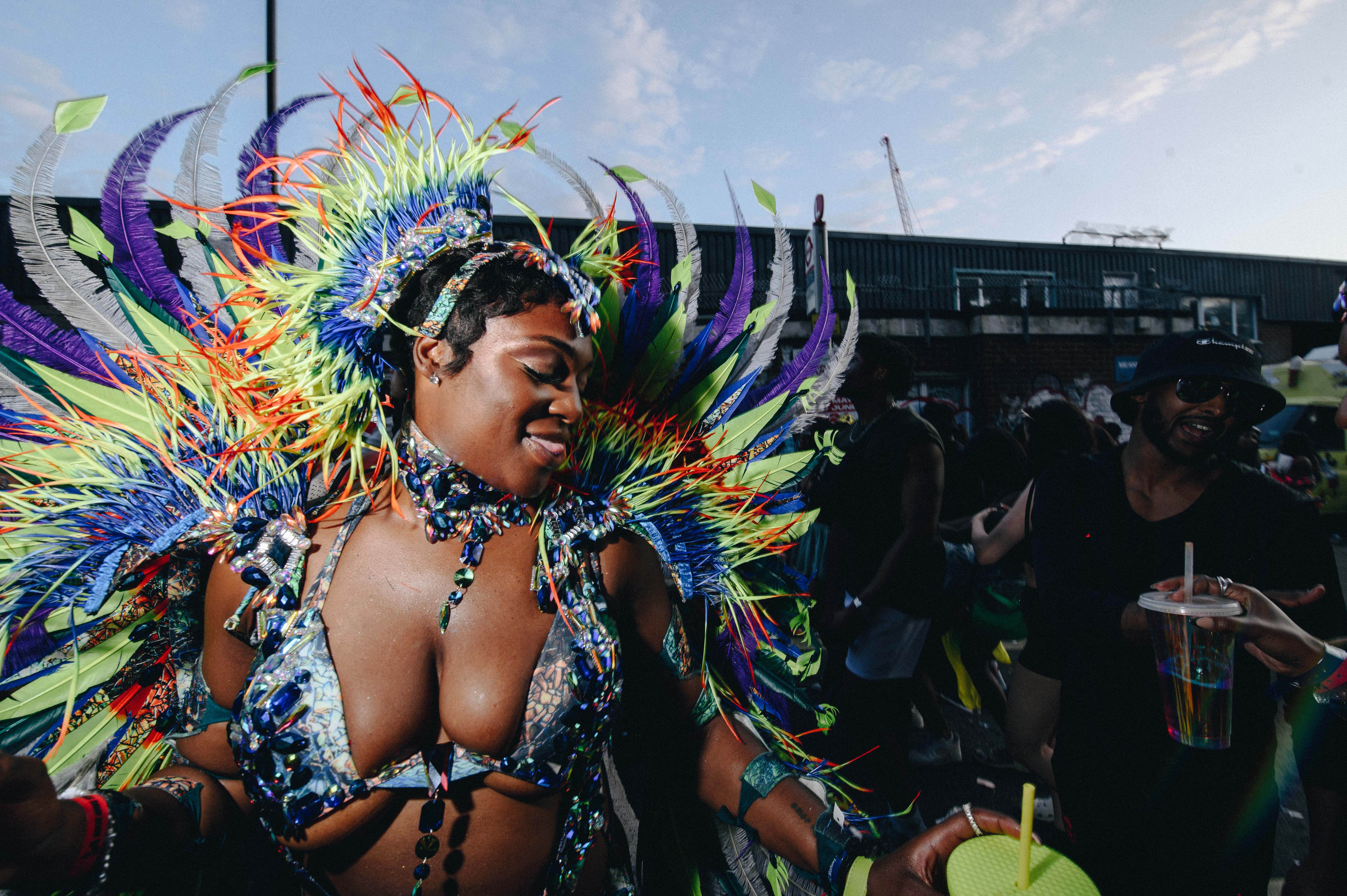 Notting Hill Carnival 2023, London: A dancer in a rainbow costume