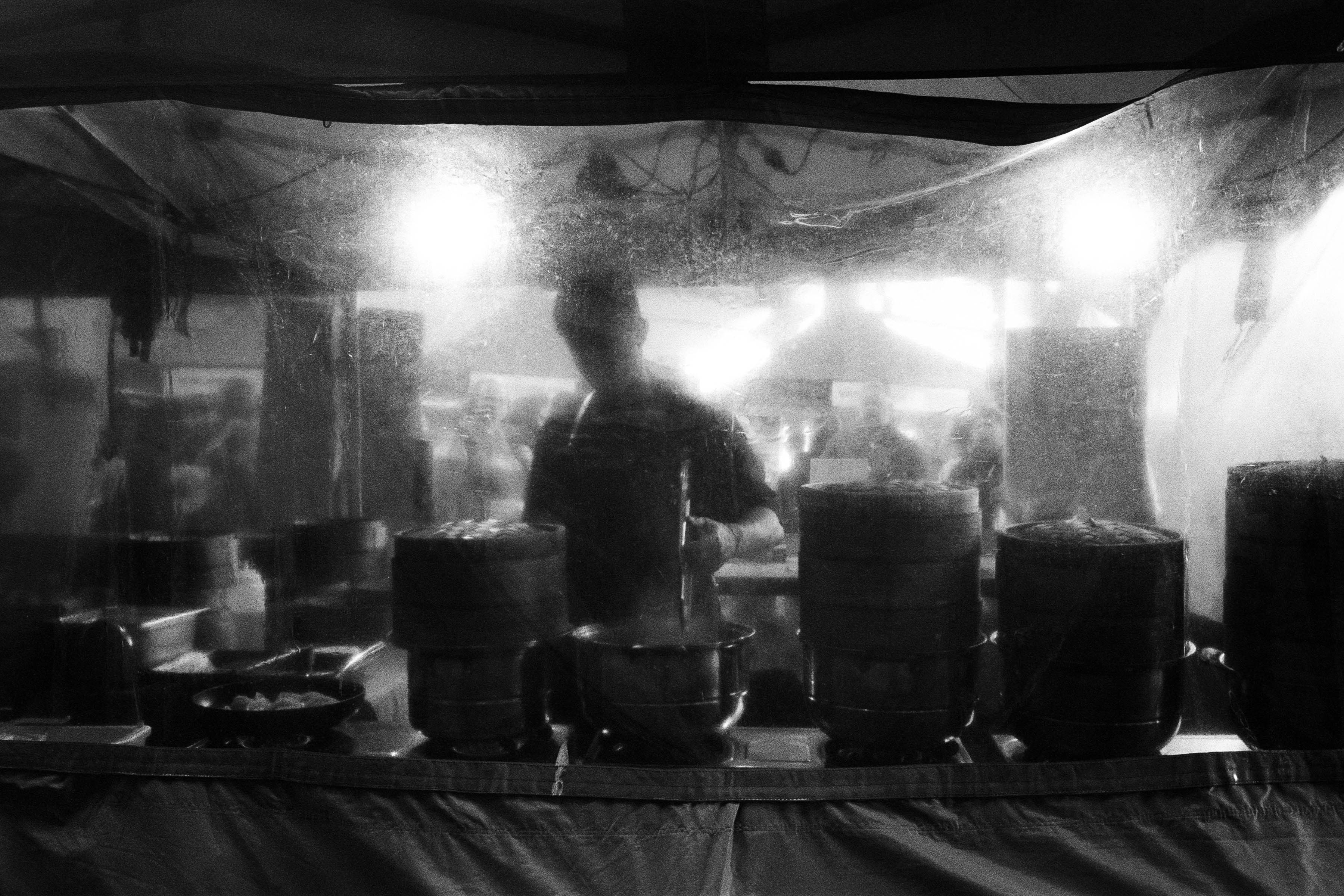 Man cooking in stall