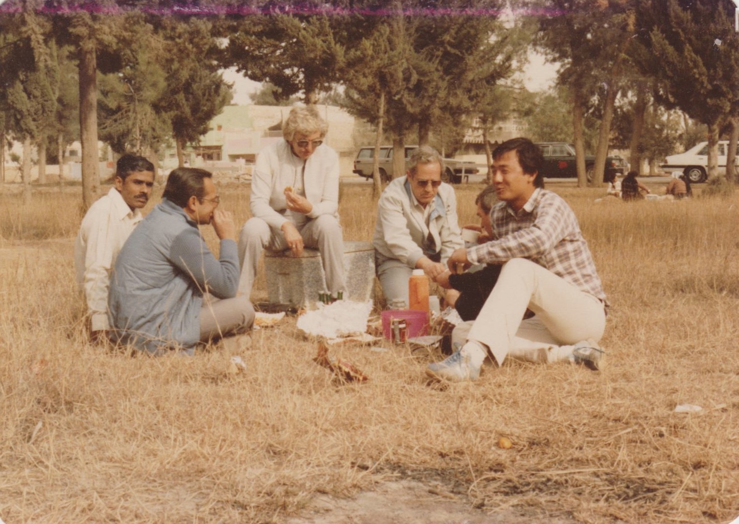 Men sitting around drinking & eating