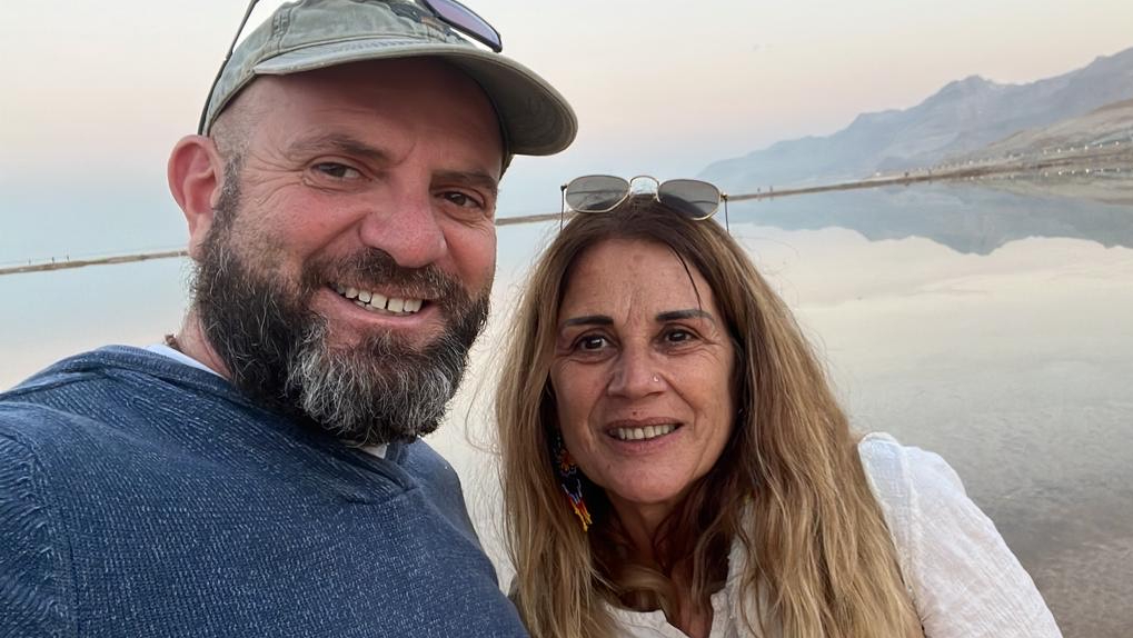 Palestinian peace activist Sami Awad and group therapist Armelle Lehman against a lake