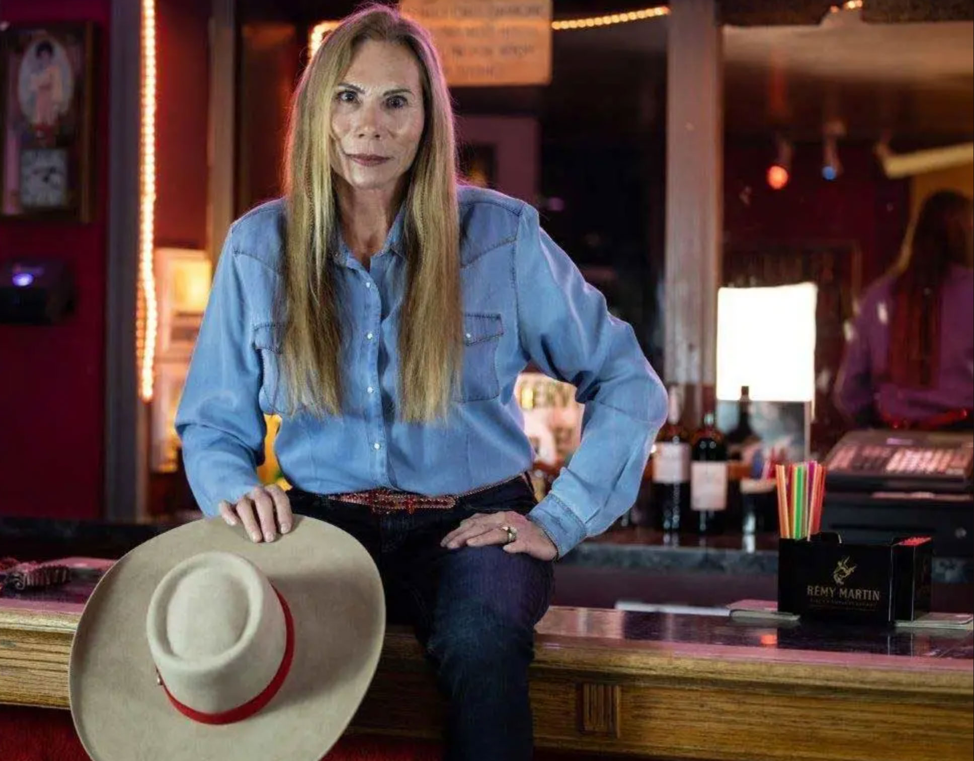 Bella's Hacienda Ranch madam Bella Cummins leaning against bar