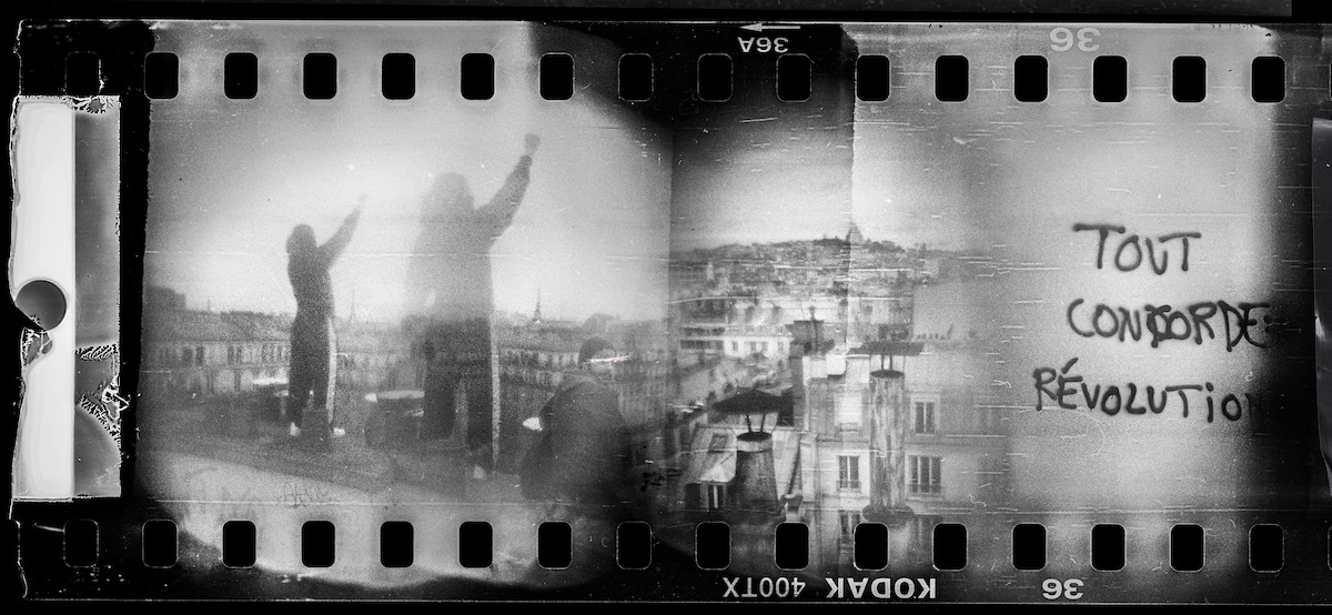 Steven Monteau photos with police weapons: black and white negatives of the city, two people raising their right hand up, and a graffiti