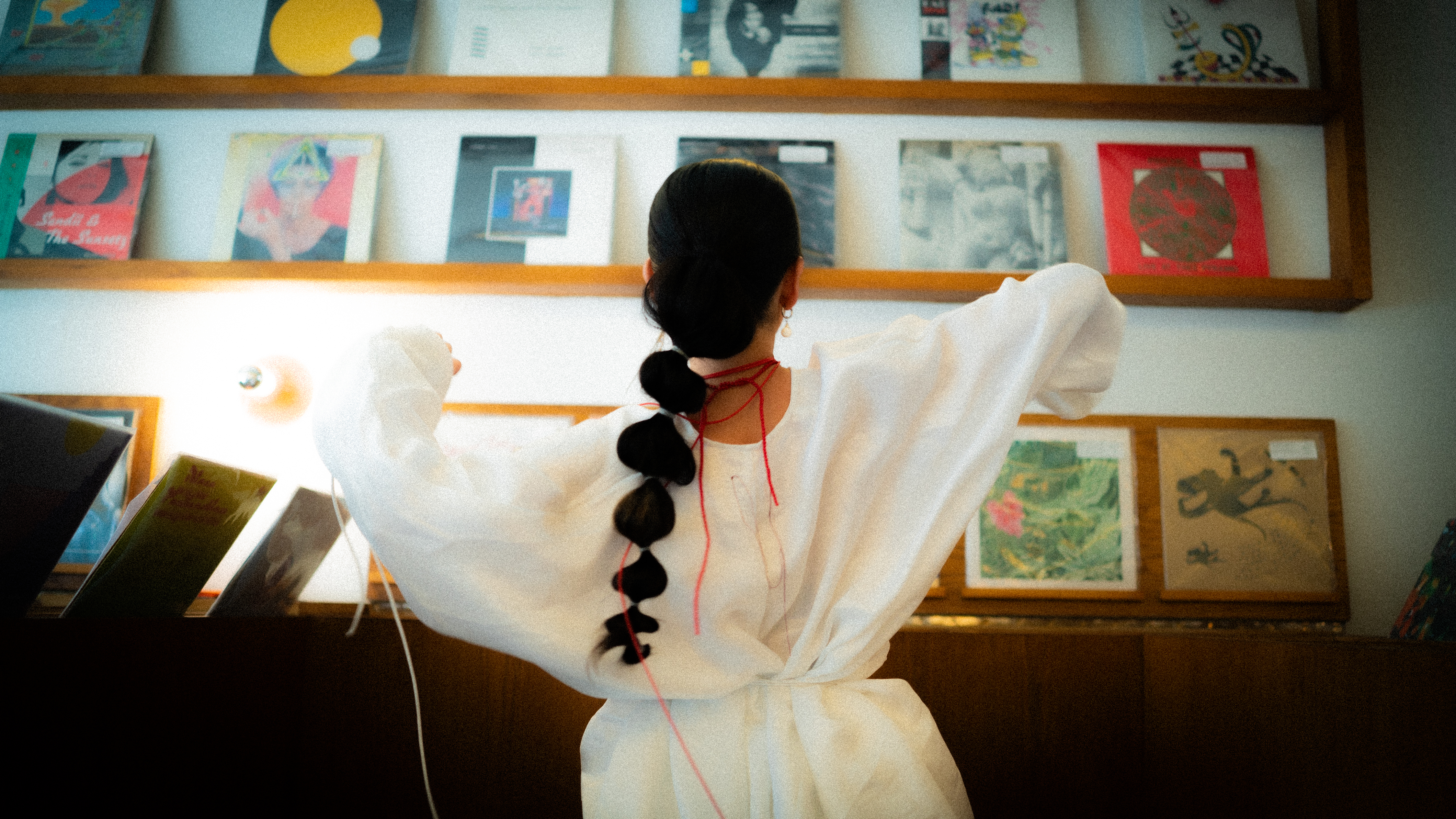Elle Shimada with her back to camera