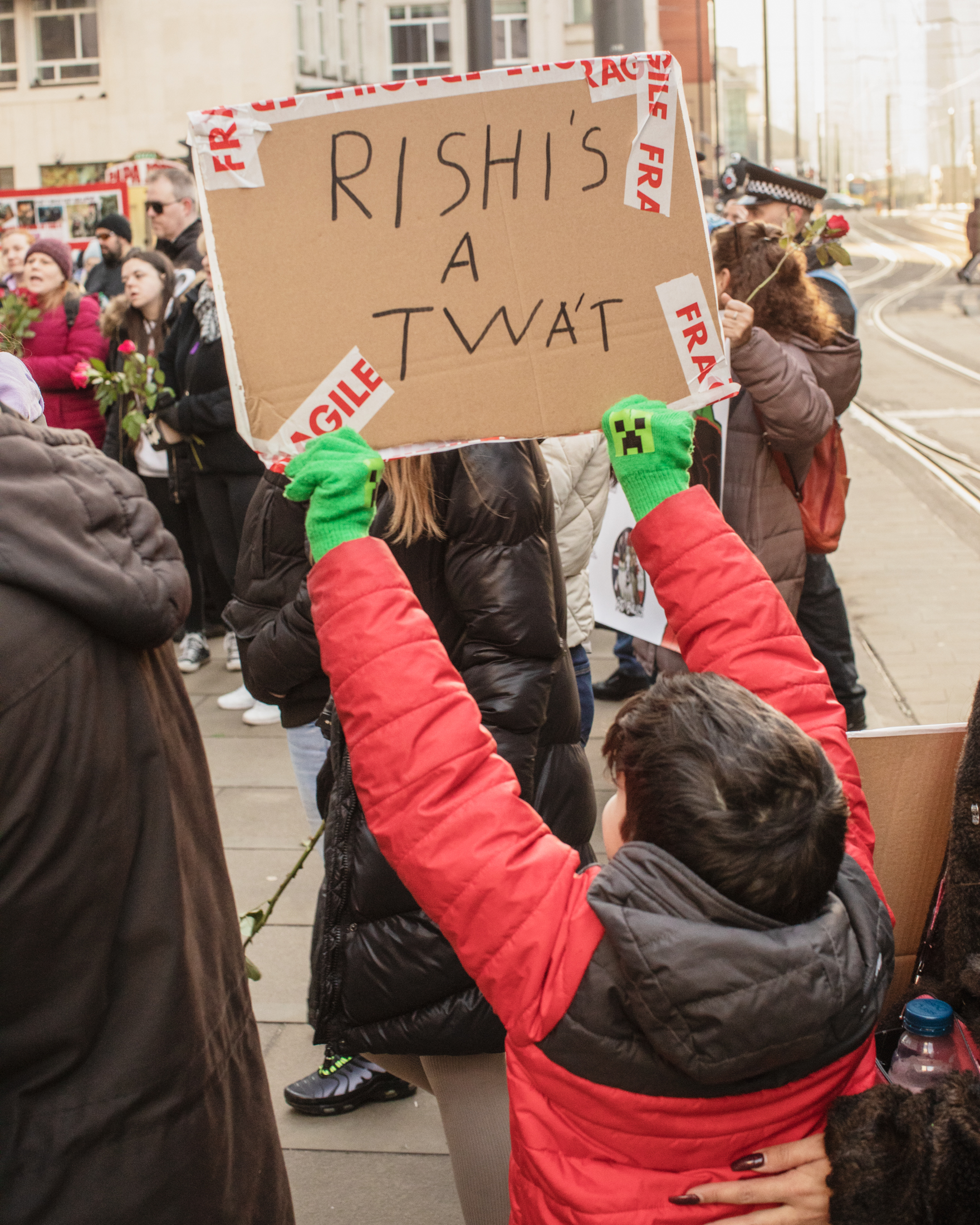 Manchester, UK: A child holds up a sign reading