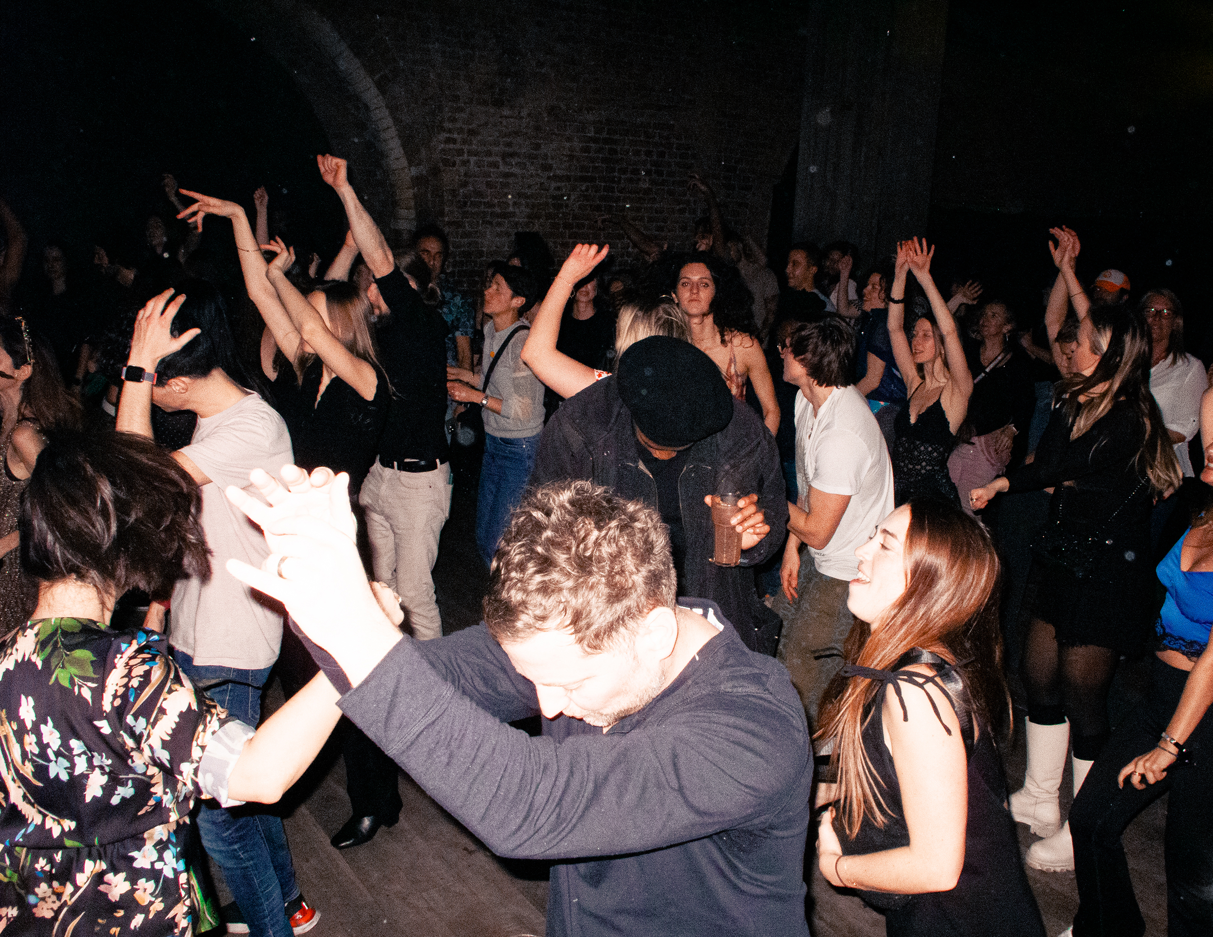 A photo taken above of a dancefloor filled with people dancing.