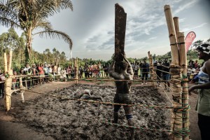 A wrestler at Soft Ground Wrestling near Kampala, Uganda, hoists aloft a plank of wood in the ring