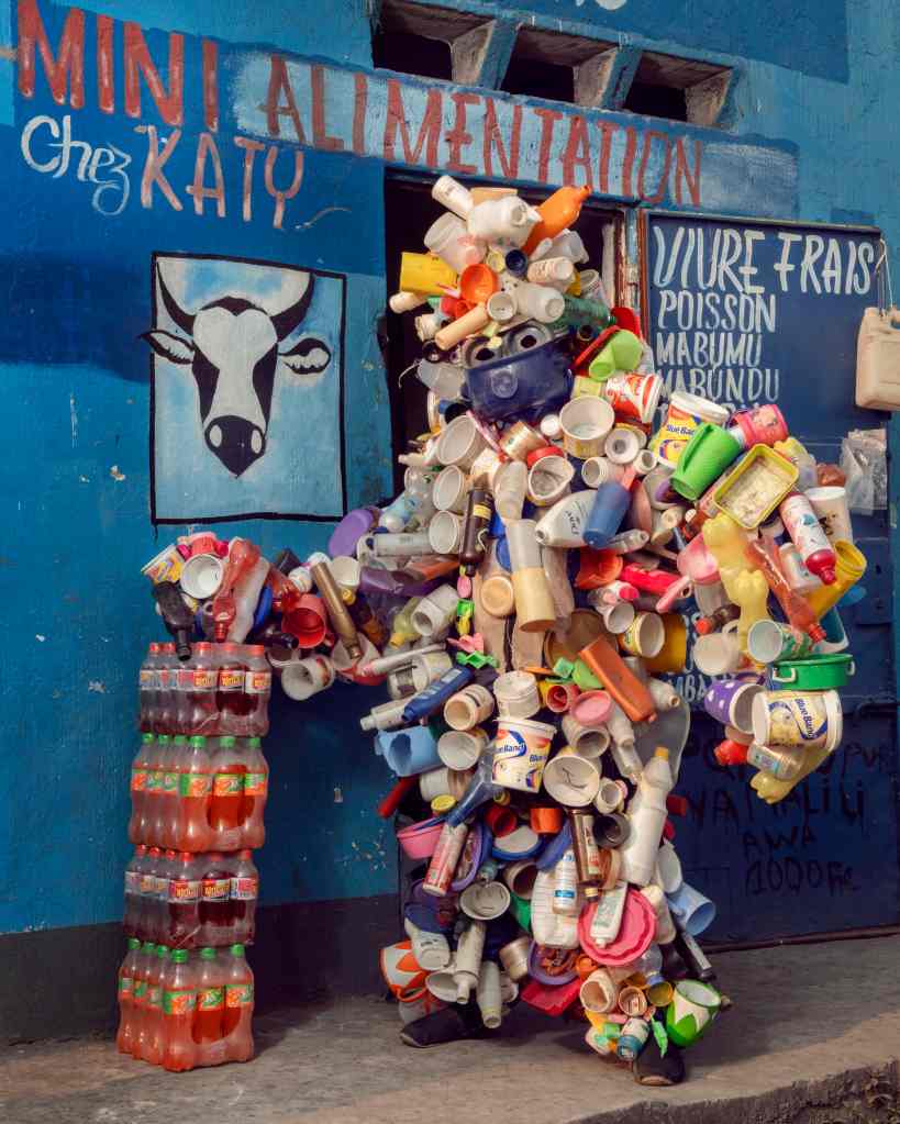 A person dressed in discarded plastic bottles
