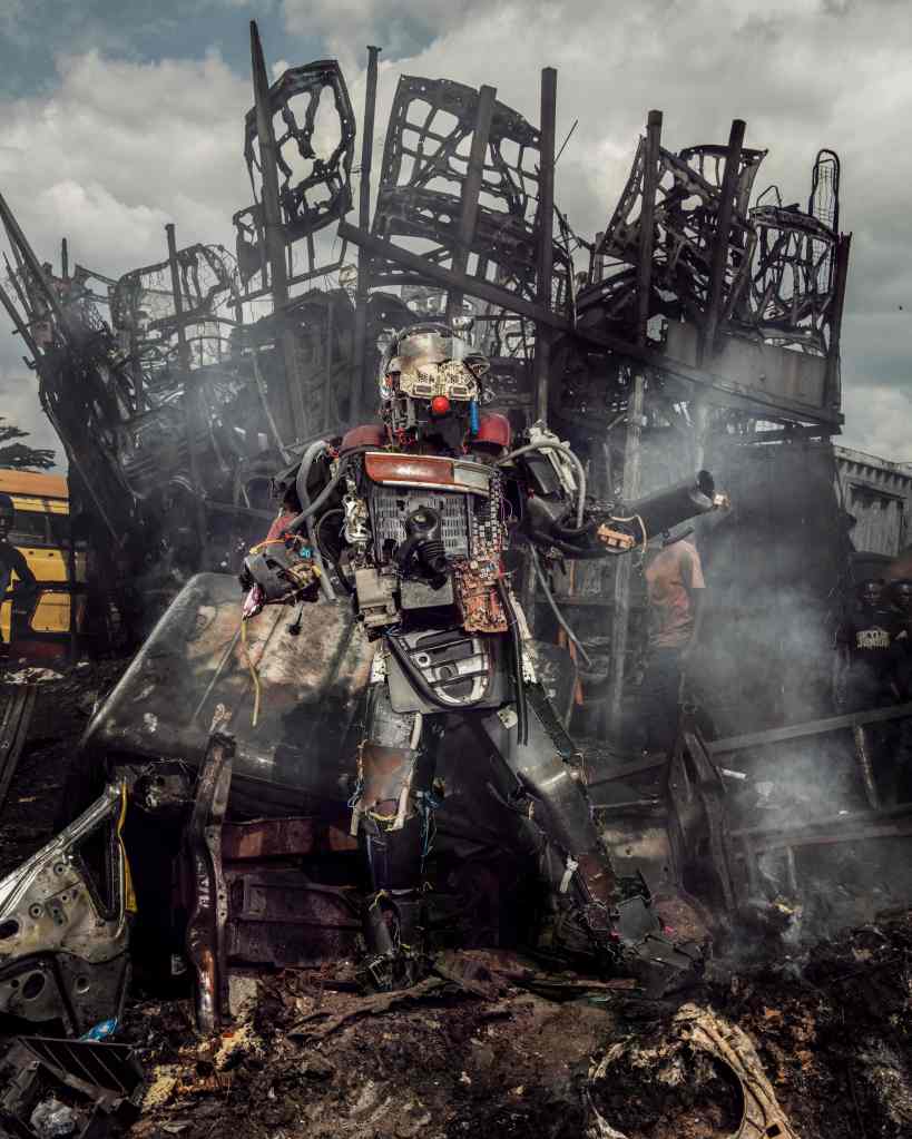 A person wearing a costume made of old car parts