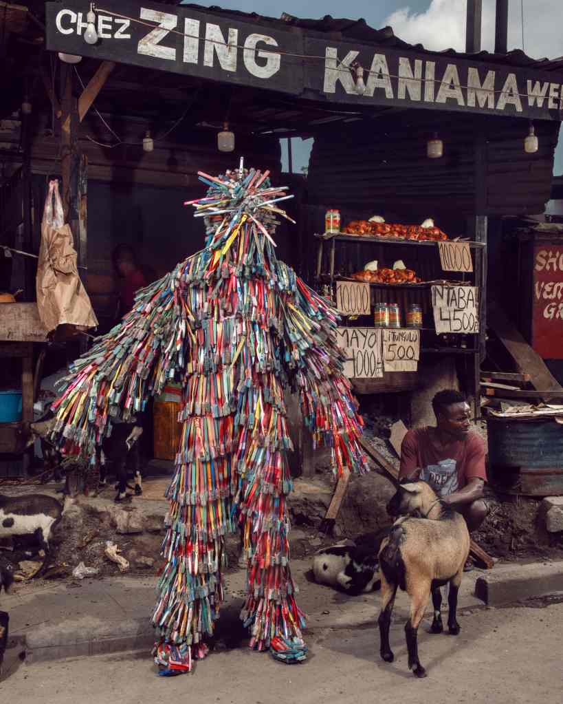 A person dressed entirely in old toothbrushes