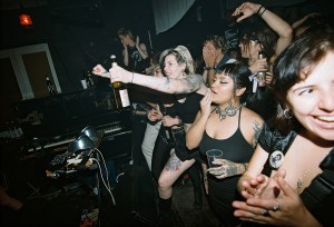 A gang of punks watch from the crowd at a hardcore show in Berlin