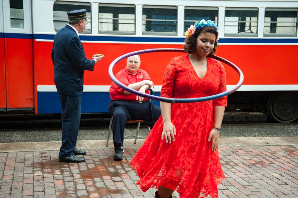 a woman spins a hoop around her neck