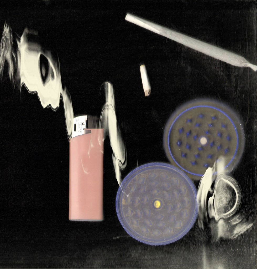 Image of a joint, lighter and weed grinders