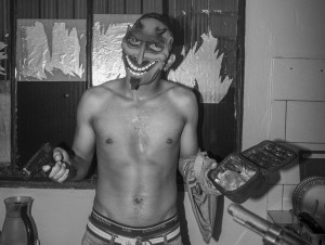 A masked man holds a gun
